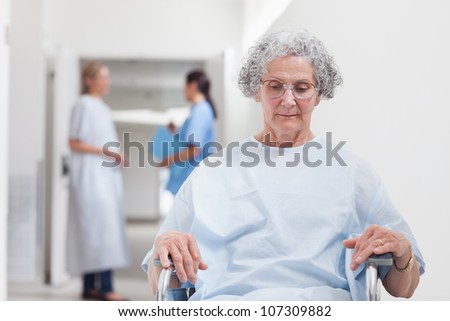 Elderly patient sitting in a wheelchair in hospital ward