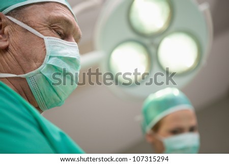 Two surgeon standing under a surgical light in a surgical light