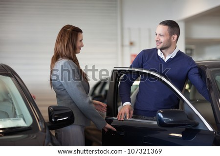 Woman opening car door  in a garage