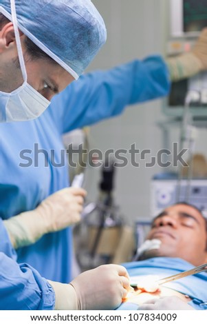 Doctor operating in operating theater