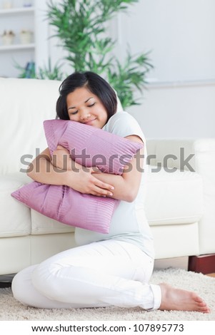 Woman holding a pillow in a living room