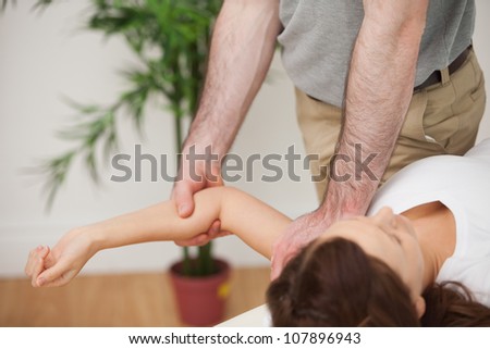 Woman lying on a medical table while being manipulated in a room