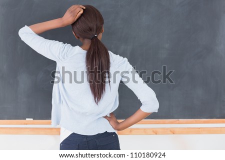 Black woman thinking in a classroom