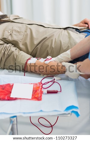 Blood bag next to male patient in hospital ward