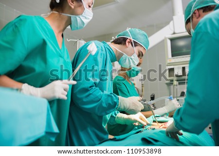 Surgeon using surgical tool in an operating theater