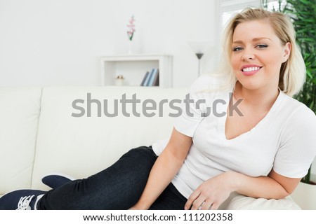 Casual woman with feet on the sofa in the living room