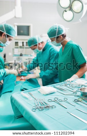 Surgical tools on a surgical tray while surgeons are operating in a hospital