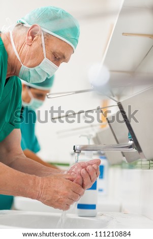 Surgeons washing their hands in a sink