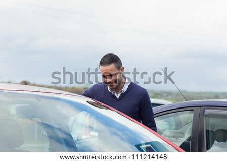 Buyer looking inside a car on a parking