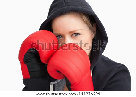 Woman boxing against white background