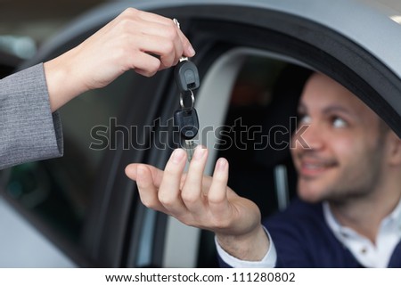 Man receiving car keys in his car