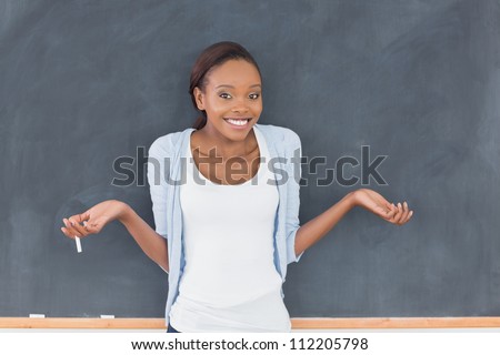 Black woman hesitating while smiling in a classroom