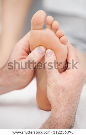 Hands massaging a foot on a medical table