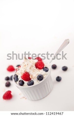 Whipped cream mix with berries against white background