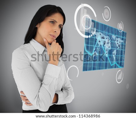 Business woman looking at world map hologram on grey background