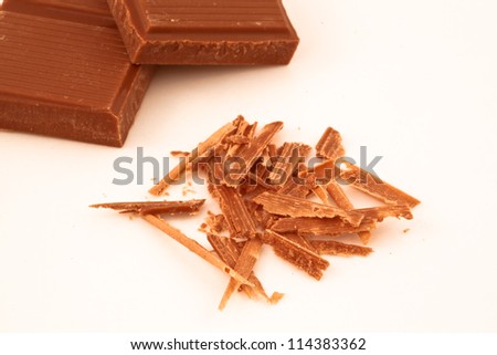 Chocolate shavings and chocolate pieces together on a white back ground