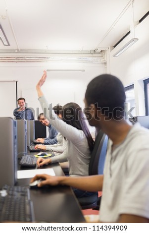 Woman raising hand in computer class