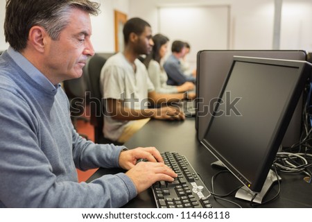 Man working at computer in computer class
