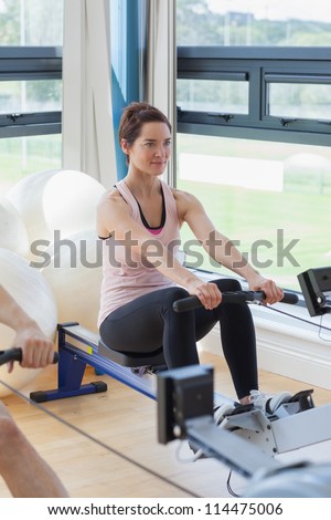 Woman rowing at the gym