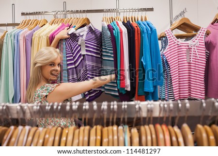 Woman looking at a clothes rack of a boutique showing clothes