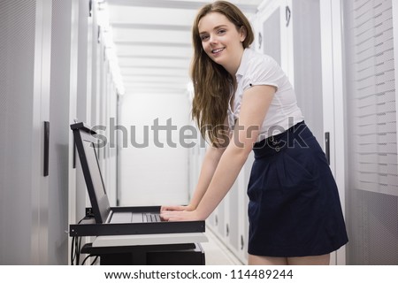 Female technician doing maintenance on servers in data center