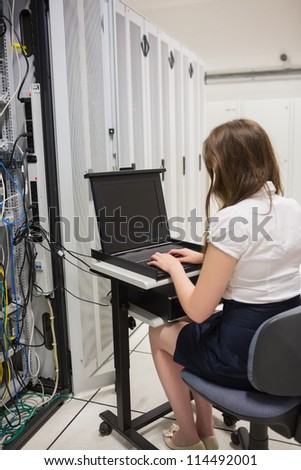 Woman working at servers in data center