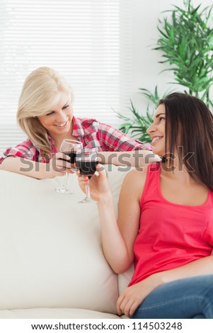 Women sitting on the couch drinking wine