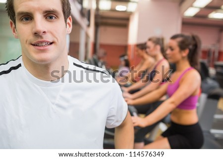 Man smiling in gym wearing white t-shirt