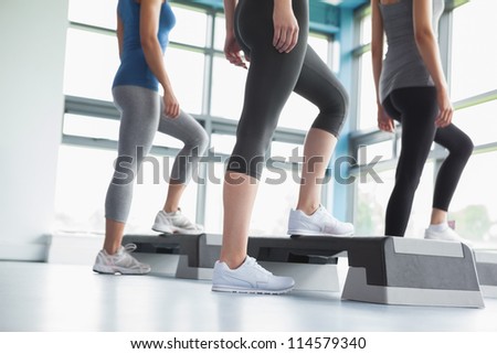 Three women in aerobics class in gym