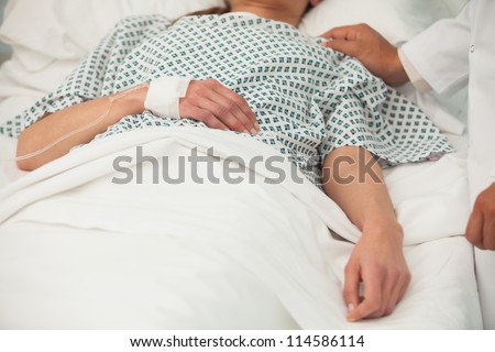 Old sick lady lying in hospital bed