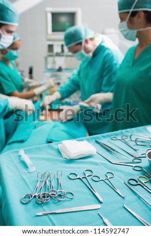 Surgical tools displayed on a surgical tray while surgeons are operating in a hospital