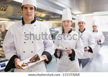 Chef\'S Presenting Deserts In The Kitchen