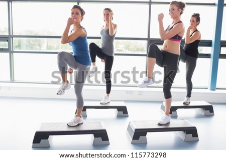 For women raising their leg swhile doing aerobics in gym