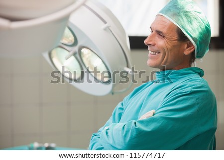 Surgeon being happy while sitting in a operating room with crossed arms