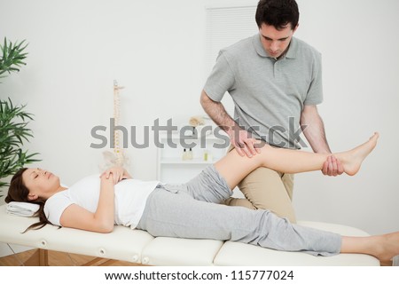 Peaceful brunette woman lying on a medical table in a physio room