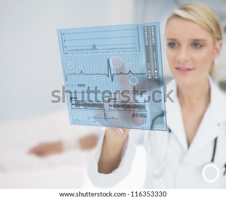 Doctor pressing on ECG line interface hologram