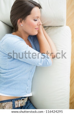 Woman lying and sleeping on sofa in the living room