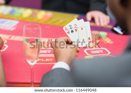 Man holding up poker hand in casino