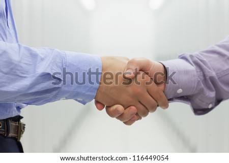 Two men shaking hands in data center