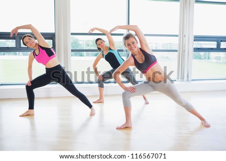Women stretching in fitness studio in the gym