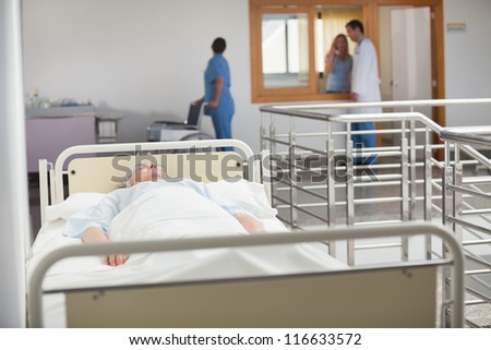 Elderly patient sleeping in hospital hallway