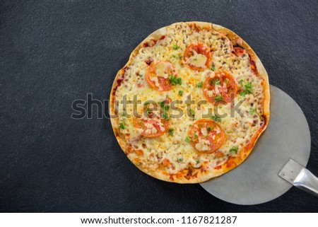 Overhead view of Italian pizza placed on a spatula