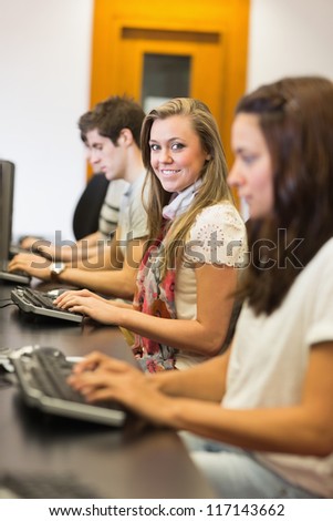 People sitting at the computer while smiling in college