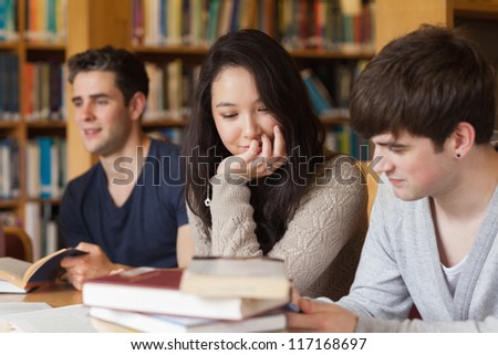 Students studying together in college library