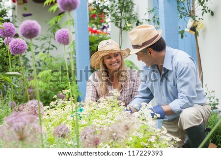 Happy couple doing the gardening at home