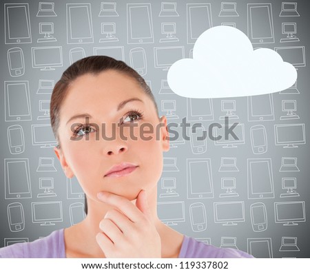 Brunette considering cloud computing on grey multimedia themed background