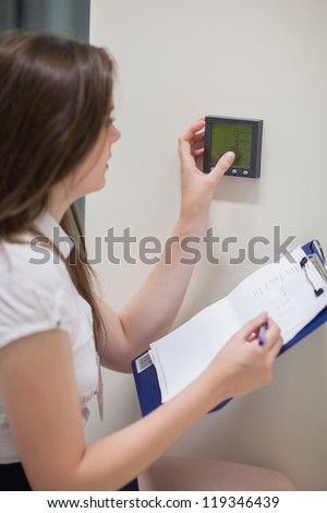 Woman setting temperature in data center