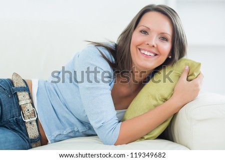 Laughing woman lying on sofa in the living room