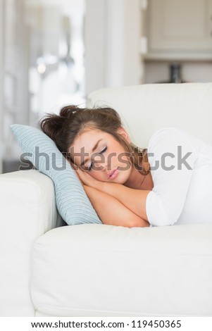 Youg woman having nap on sofa