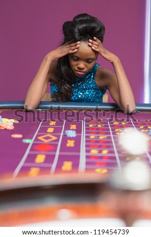 Woman losing at roulette in casino